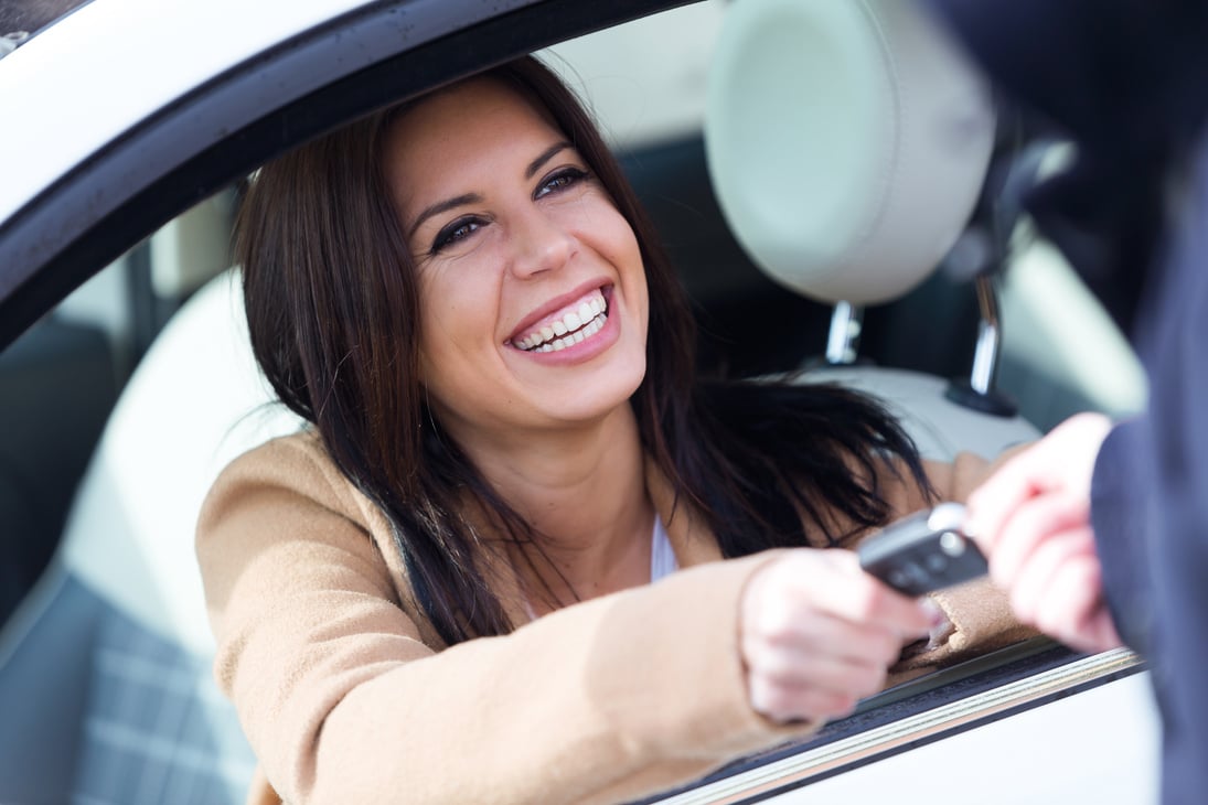 Car Rental Agency Employee Giving Car Keys to Beautiful Young Wo